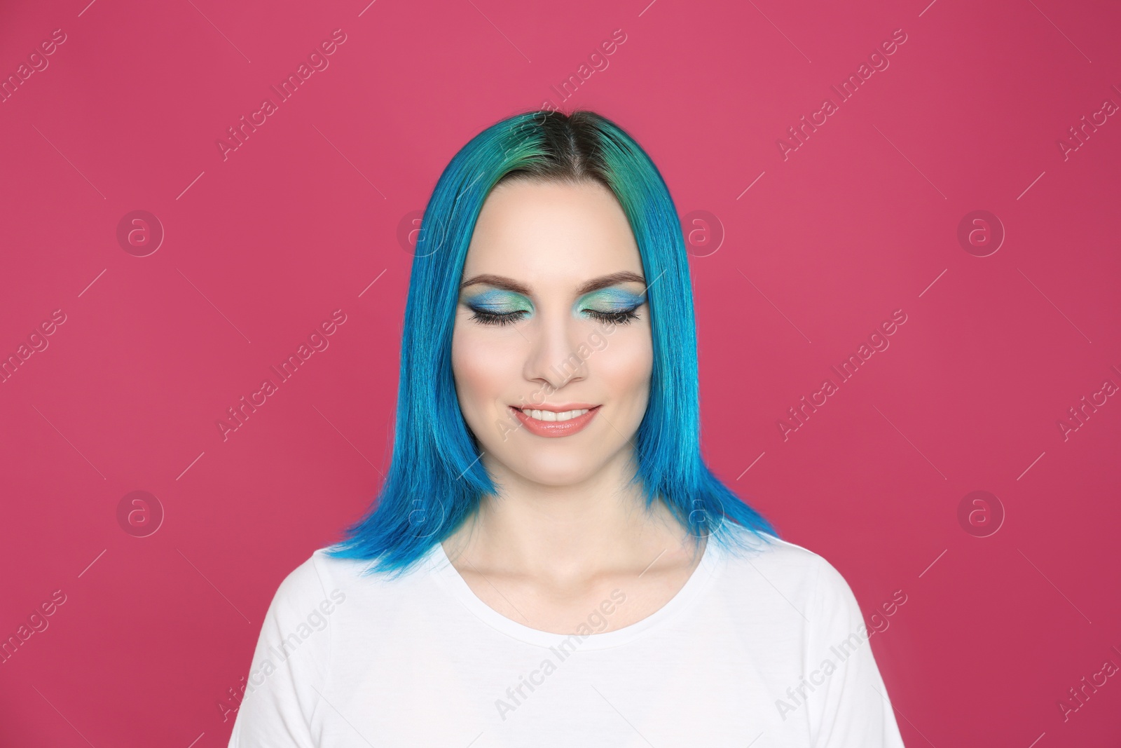 Photo of Young woman with bright dyed hair on pink background