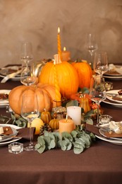 Beautiful autumn place setting and decor on table in room