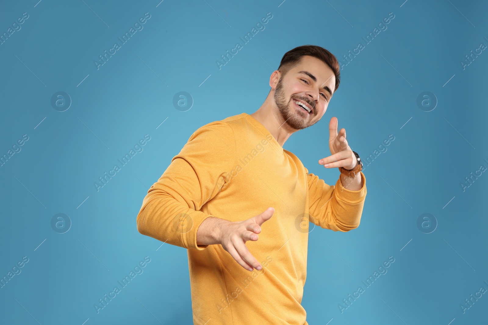 Photo of Portrait of handsome young man on color background