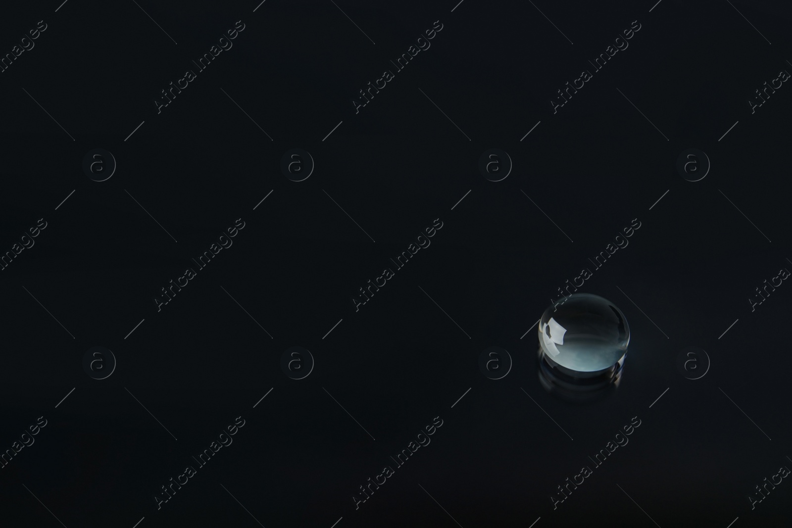 Photo of Beautiful clean water drop on black background