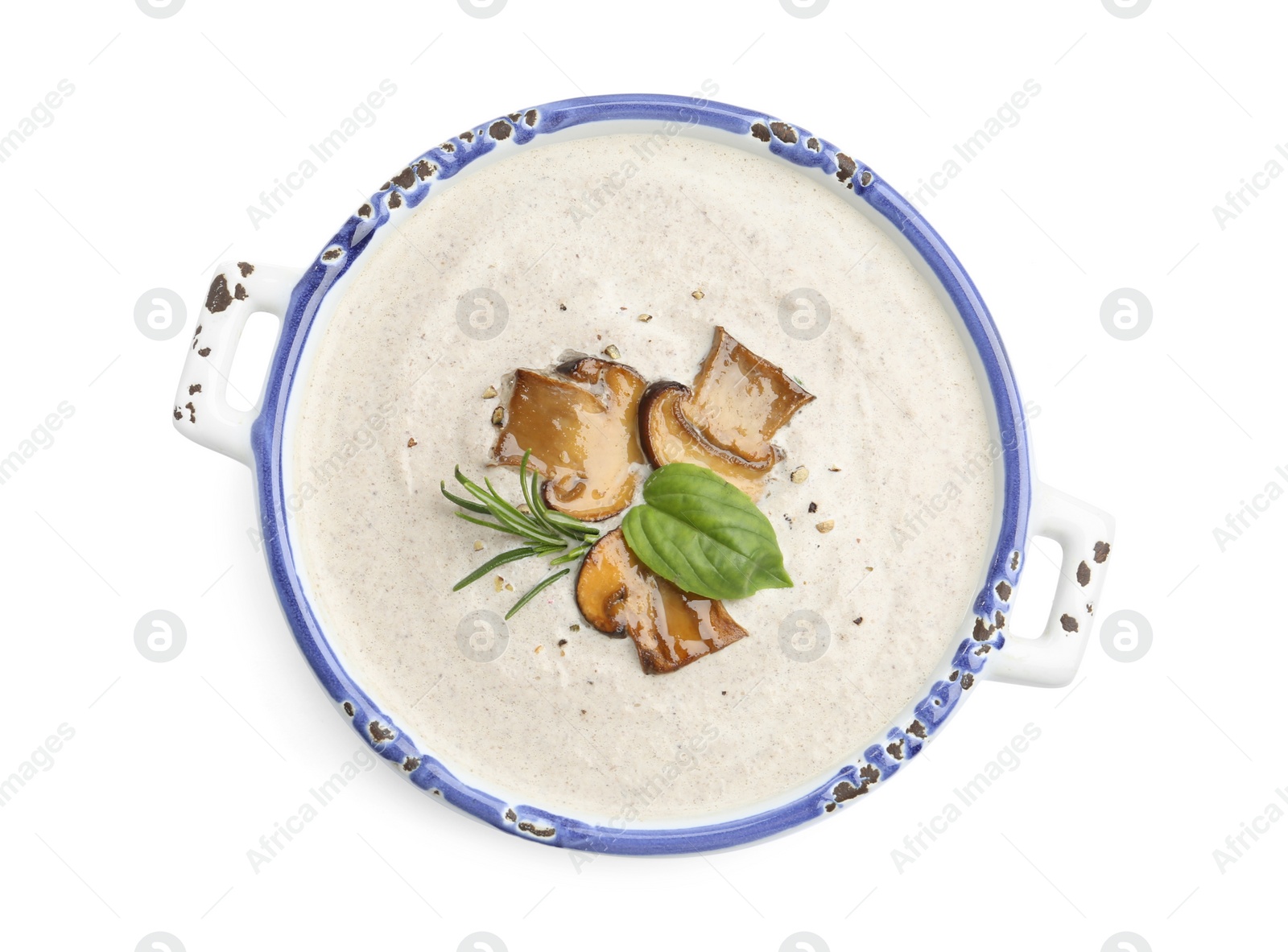 Photo of Fresh homemade mushroom soup in ceramic pot isolated on white, top view