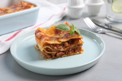 Photo of Tasty cooked lasagna served on grey table