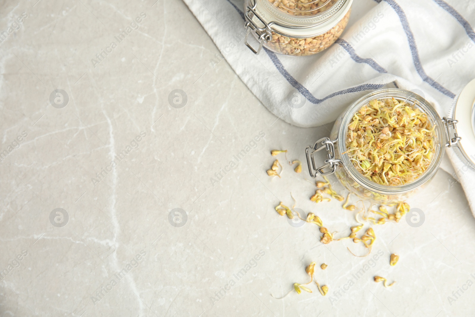 Photo of Flat lay composition with green buckwheat on light table, space for text