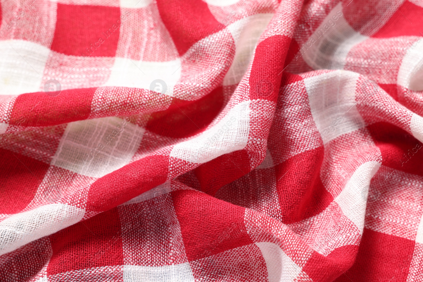 Photo of Texture of crumpled checkered fabric as background, closeup