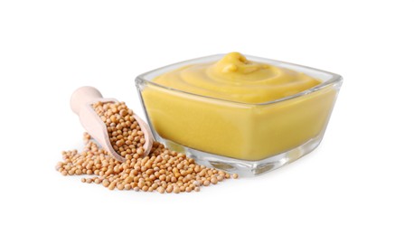 Photo of Bowl of delicious mustard and scoop with seeds on white background