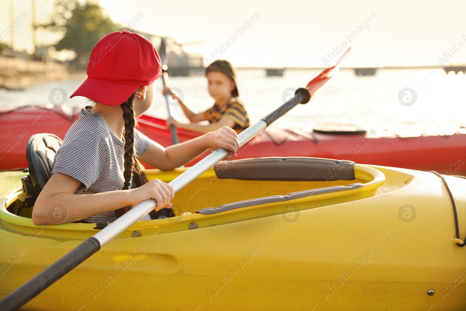 Photo of Little children kayaking on river. Summer camp activity