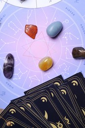 Photo of Astrology prediction. Zodiac wheel, tarot cards and gemstones, flat lay