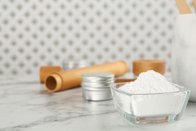 Photo of Tooth powder on white marble table, closeup. Space for text