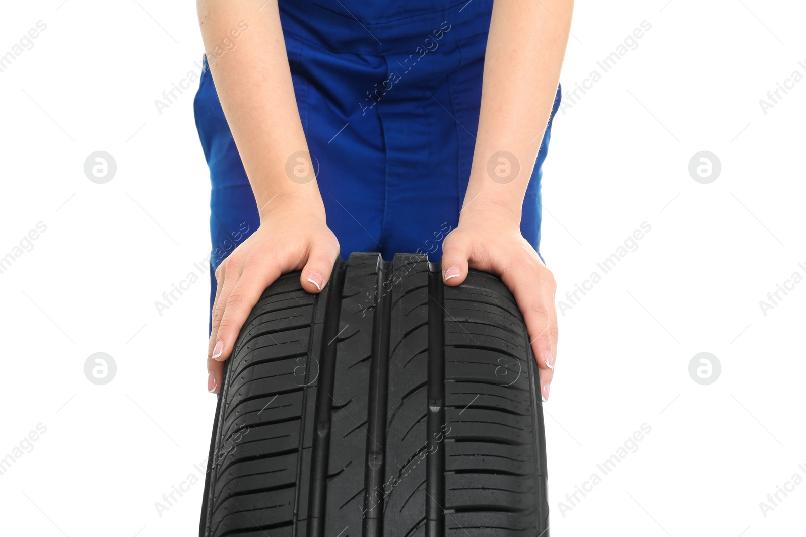 Photo of Female mechanic with car tire on white background, closeup