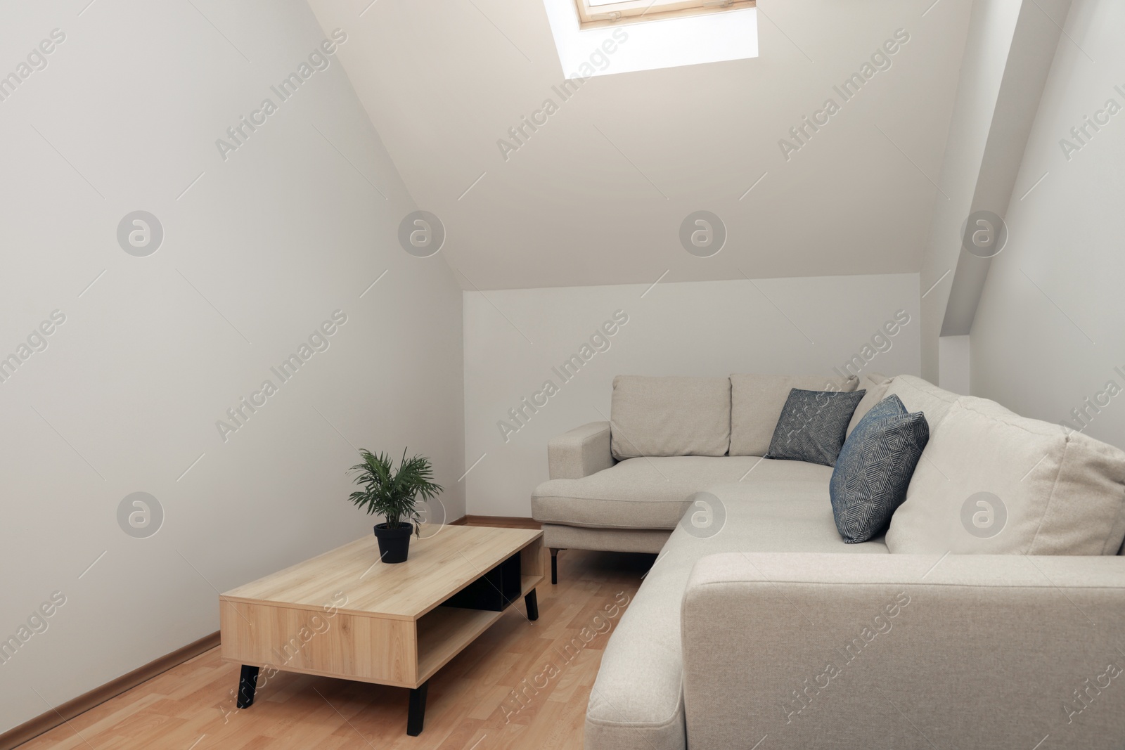 Photo of Attic room interior with slanted ceiling and furniture