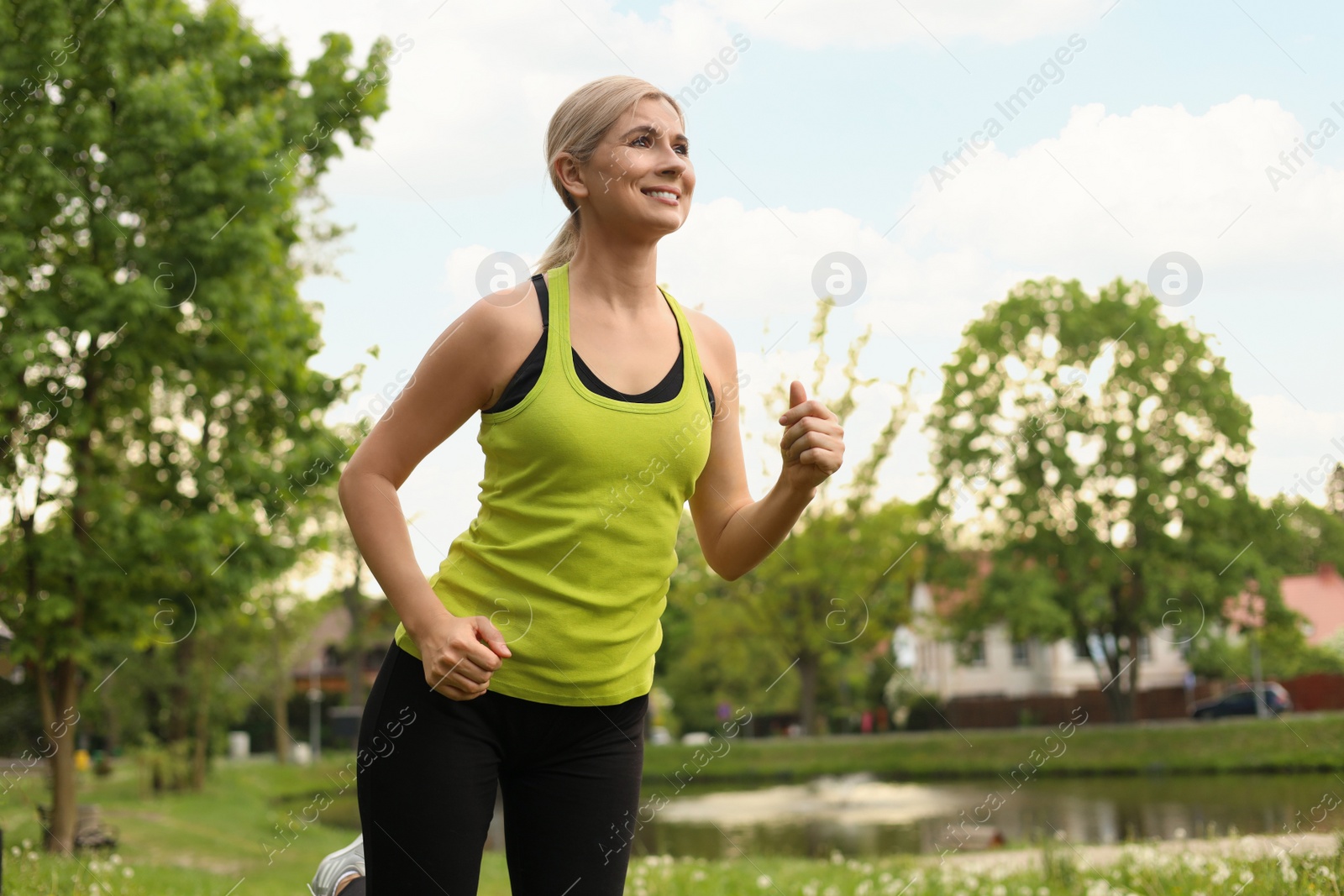 Photo of Beautiful woman jogging around park in morning