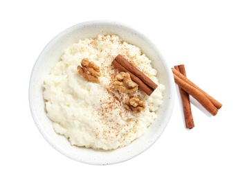 Photo of Creamy rice pudding with cinnamon and walnuts in bowl on white background, top view