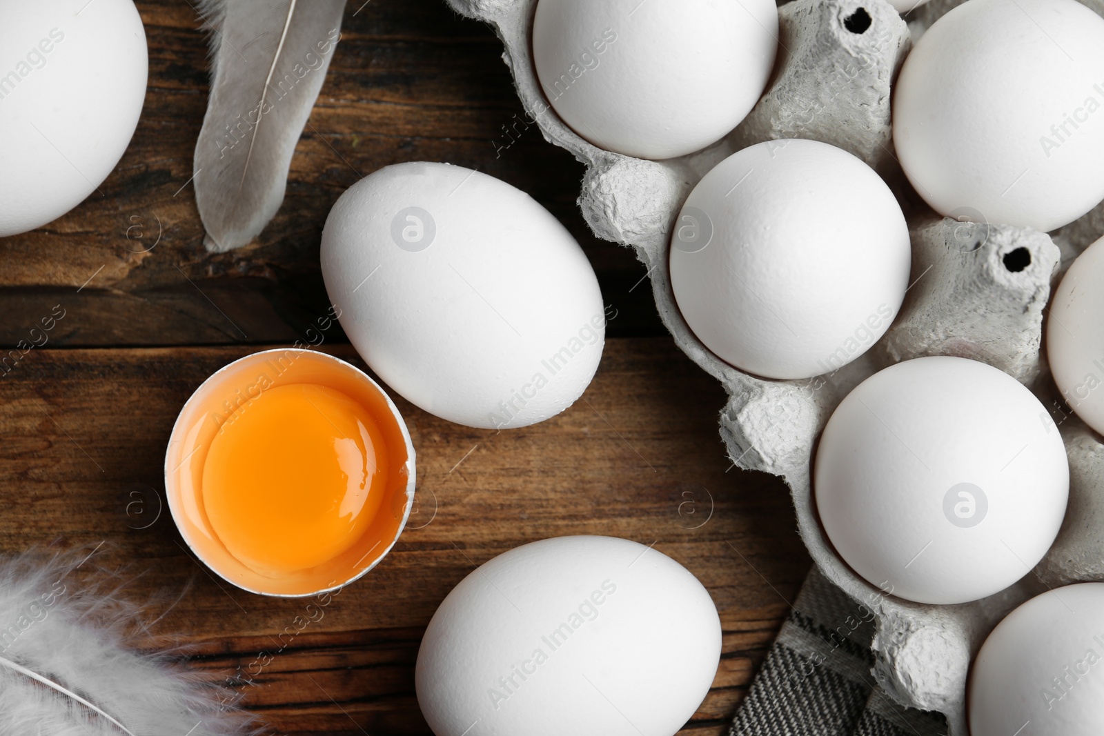 Photo of Flat lay composition with fresh raw chicken eggs on wooden table