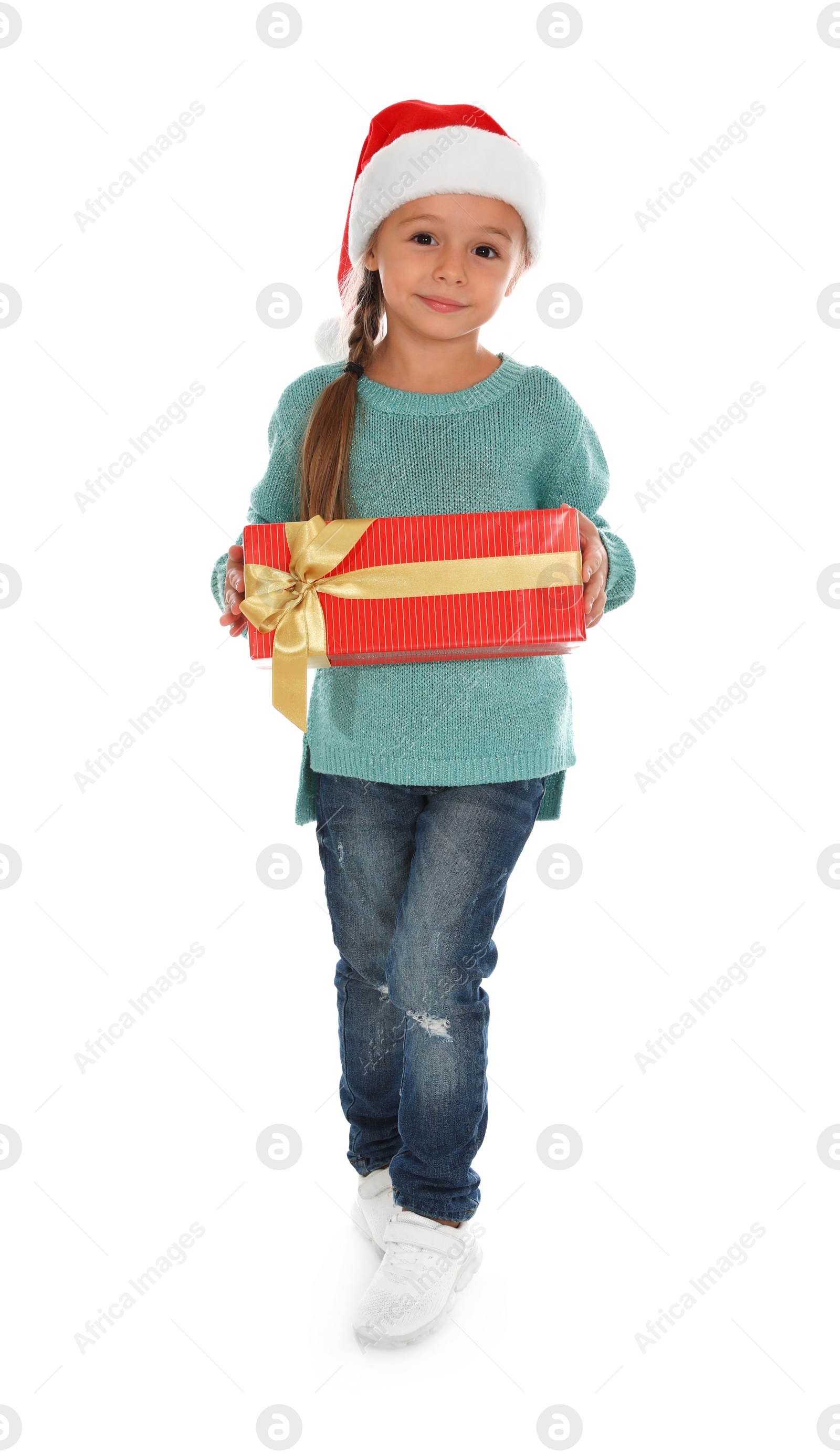 Photo of Cute little girl in Santa hat with Christmas gift on white background