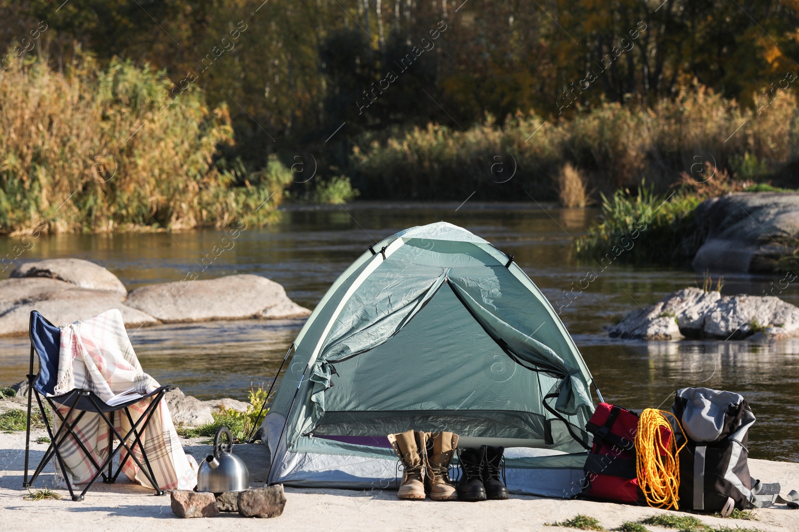 Photo of Set of equipment near camping tent outdoors