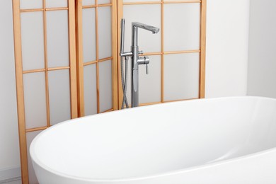 Photo of White ceramic tub in bathroom. Interior design