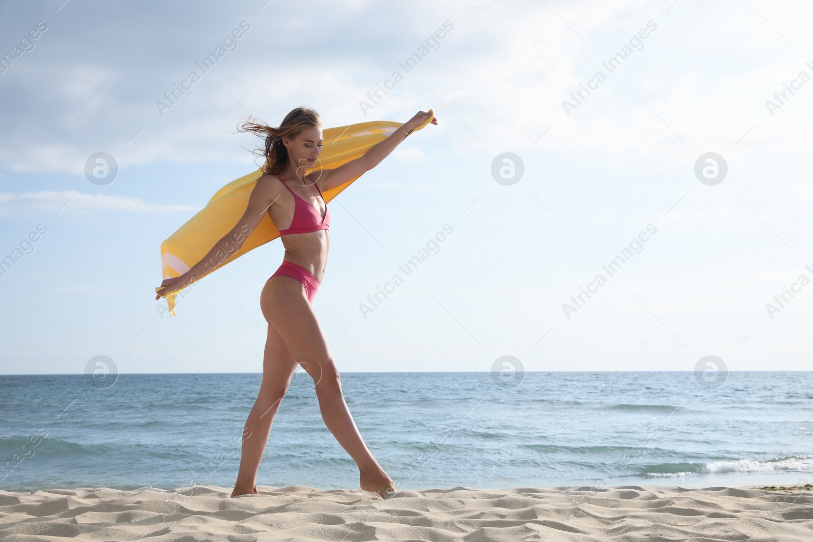 Photo of Beautiful woman with beach towel near sea