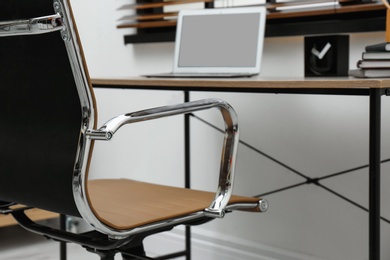 Stylish workplace interior with modern office chair