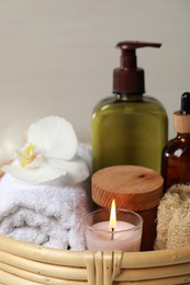 Photo of Beautiful composition with different spa products and burning candle, closeup