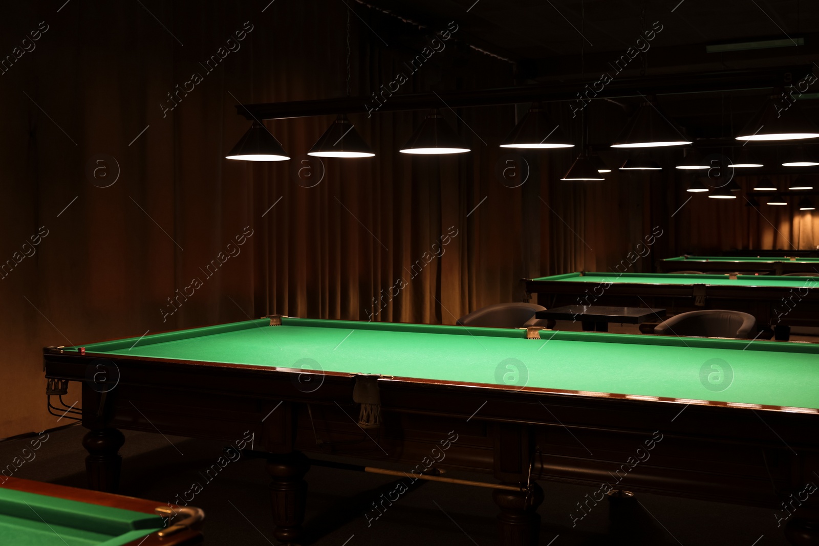 Photo of Empty green billiard tables in club. Pool Game