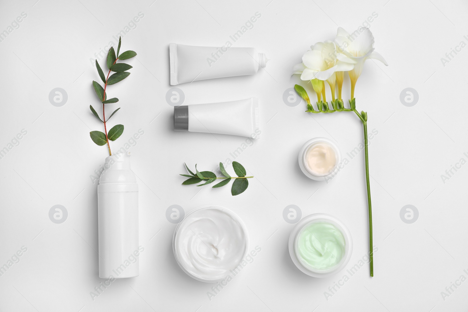 Photo of Flat lay composition with cosmetic products on light background