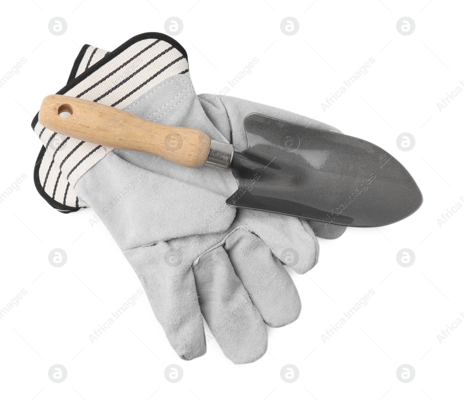 Photo of Gardening gloves and trowel isolated on white, top view