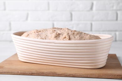 Fresh sourdough in proofing basket on light table