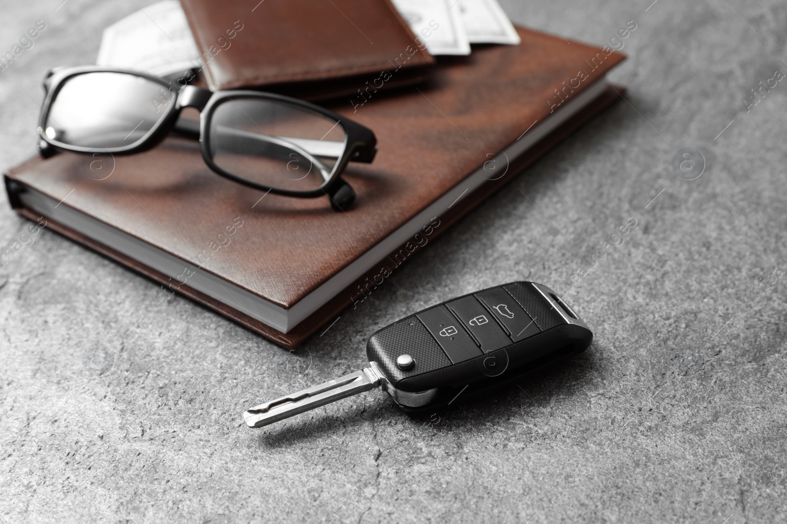 Photo of Composition with male accessories and car key on grey background