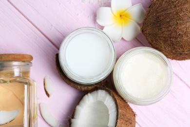 Photo of Beautiful composition with coconut oil and nuts on color wooden background