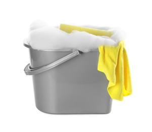 Photo of Plastic bucket with foam and sponge on white background. Cleaning supplies
