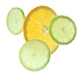 Photo of Slices of citrus fruits in sparkling water on white background