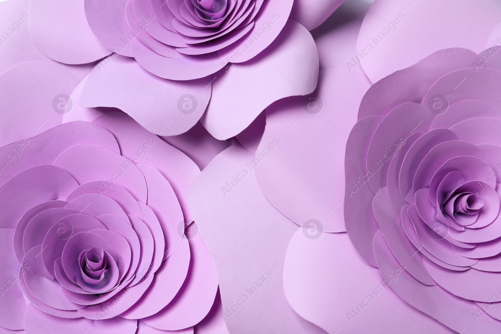 Photo of Beautiful violet flowers made of paper as background, top view