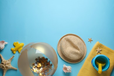 Photo of Flat lay composition with ball and beach objects on light blue background, space for text