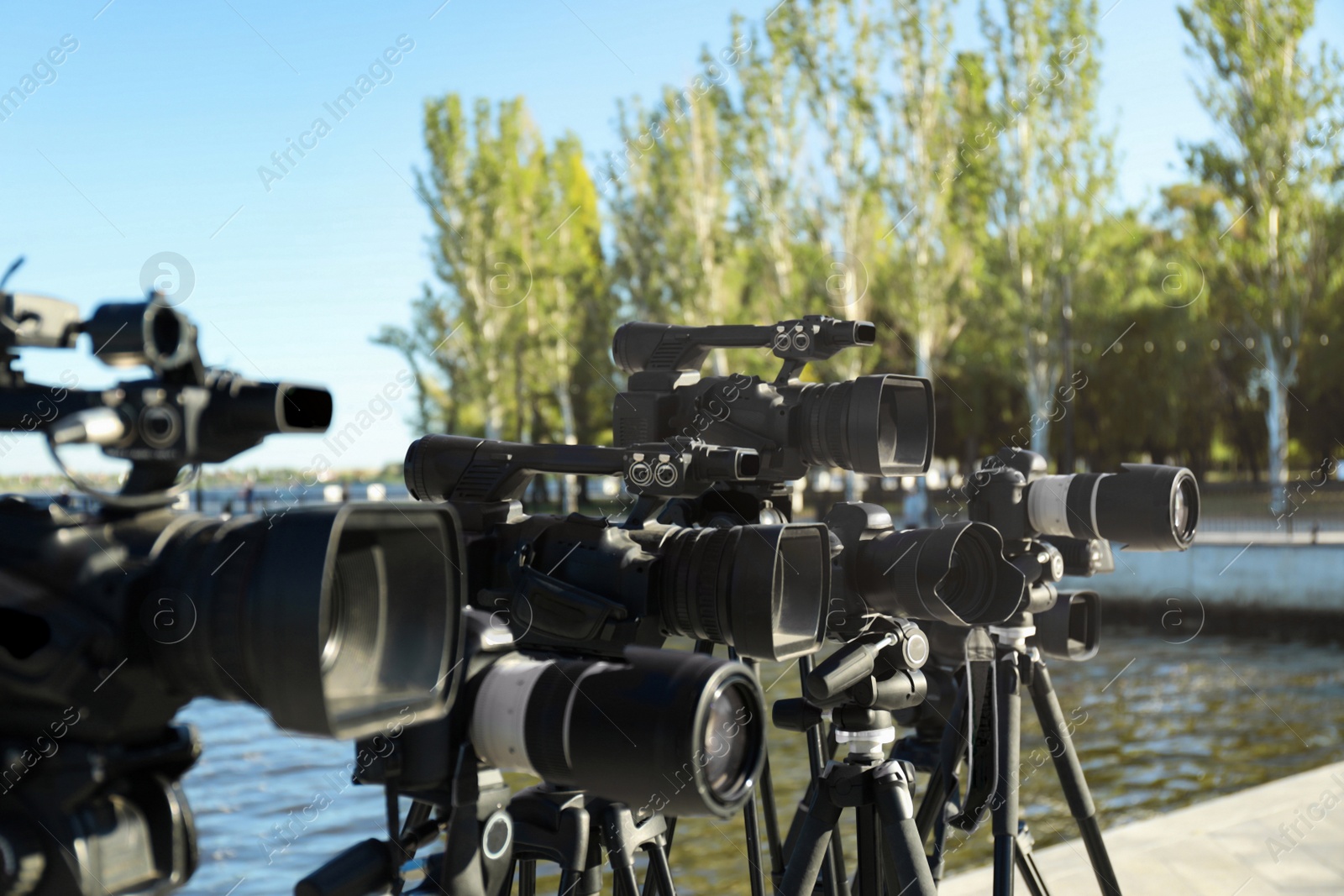 Photo of Modern professional video cameras outdoors on sunny day