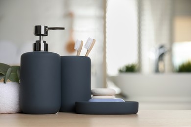 Image of Bath accessories. Different personal care products and eucalyptus leaves on wooden table in bathroom, space for text