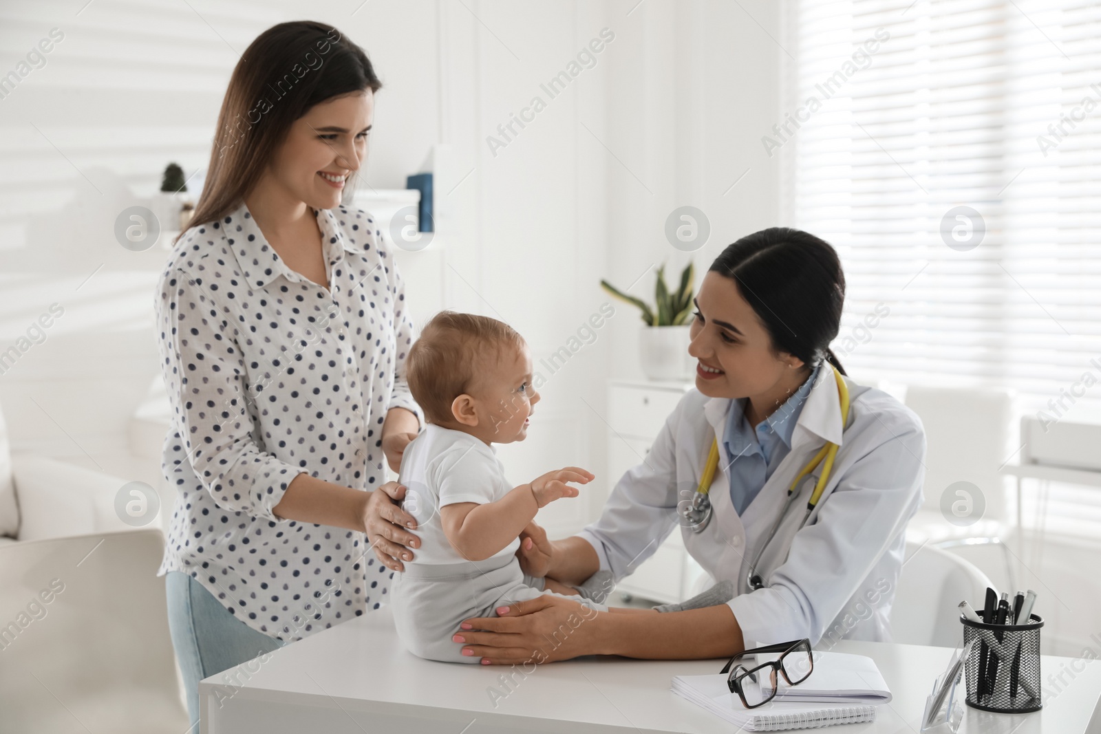 Photo of Mother with her cute baby visiting pediatrician in clinic