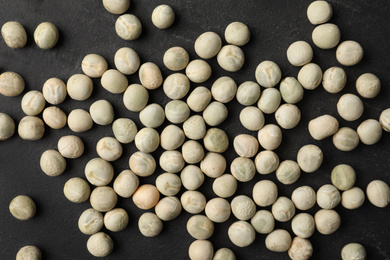 Photo of Raw dry peas on black background, flat lay. Vegetable seeds