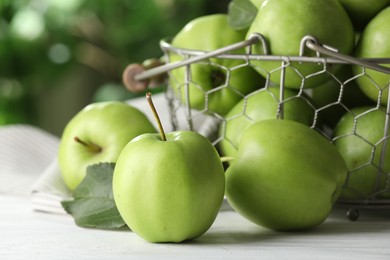 Photo of Ripe green apples on white table outdoors, closeup