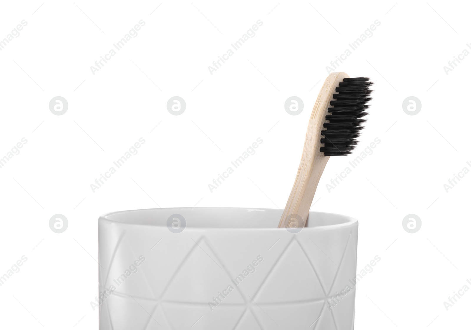 Photo of Bamboo toothbrush in holder isolated on white