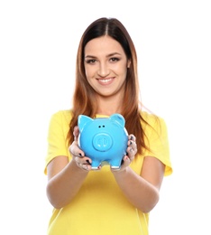 Young woman with piggy bank on white background