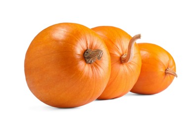 Photo of Many fresh orange pumpkins isolated on white