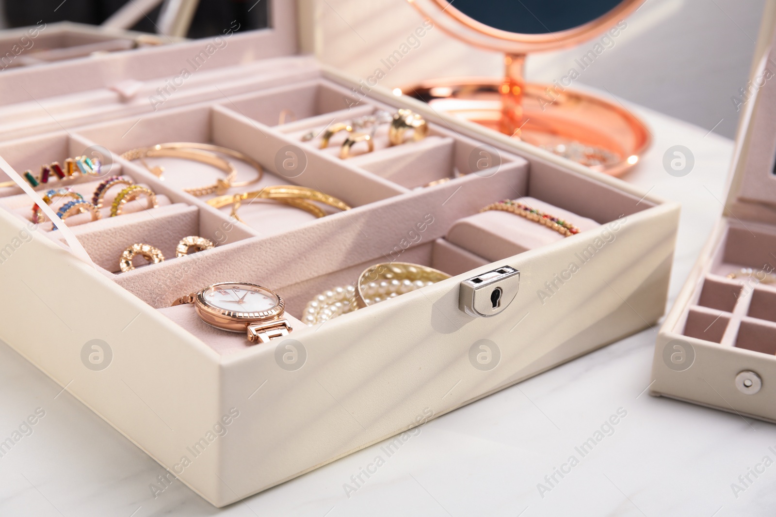 Photo of Jewelry box with stylish golden bijouterie on white table