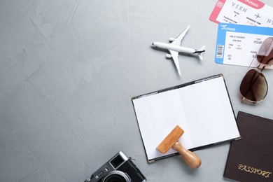 Photo of Flat lay composition with passports and visa stamp on grey table. Space for text