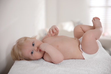 Photo of Cute little baby on changing table indoors