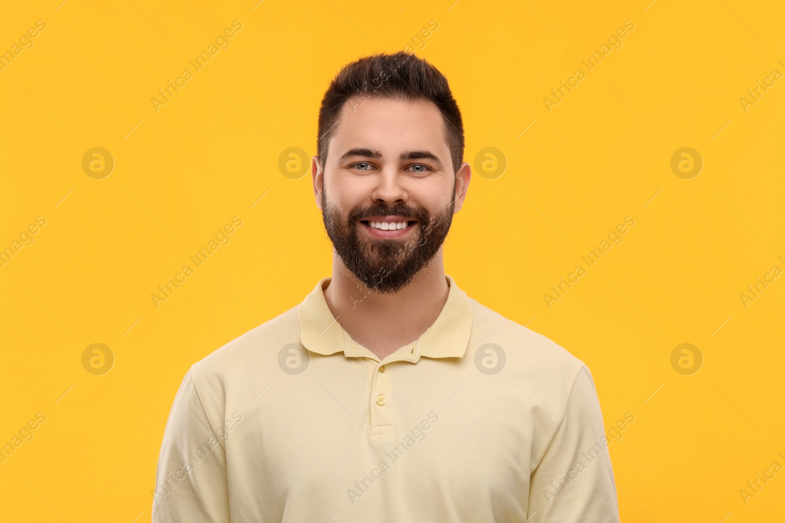 Photo of Man with clean teeth smiling on yellow background