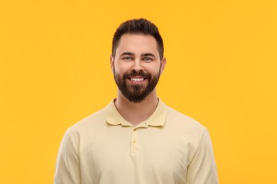Photo of Man with clean teeth smiling on yellow background