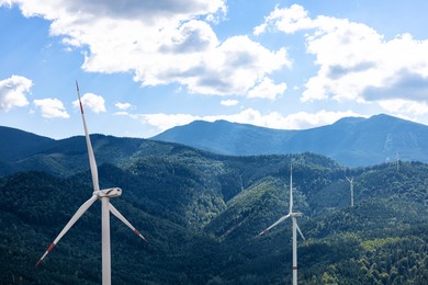 Image of Modern wind turbines in mountains. Alternative energy source
