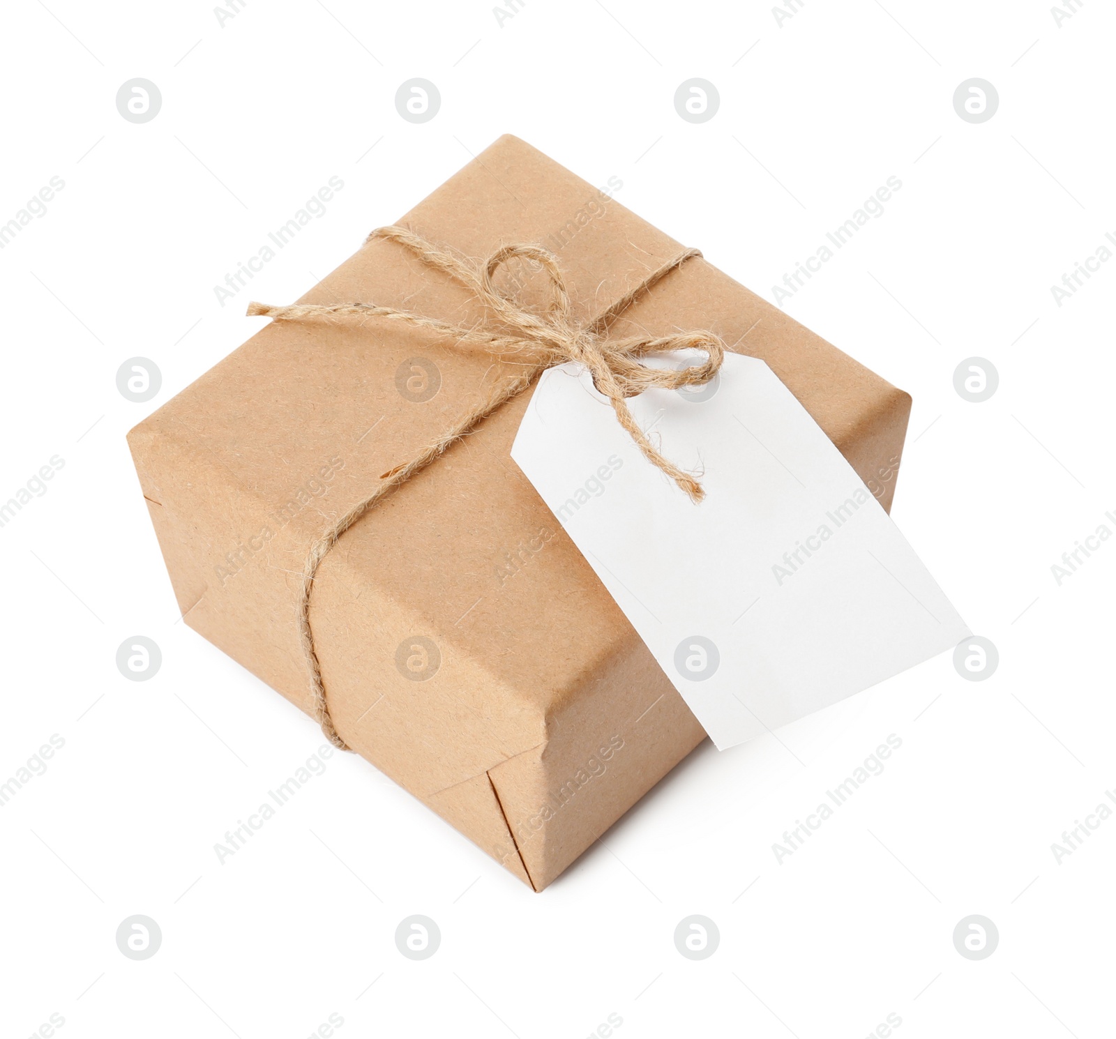 Photo of Gift box wrapped in kraft paper with bow and tag isolated on white