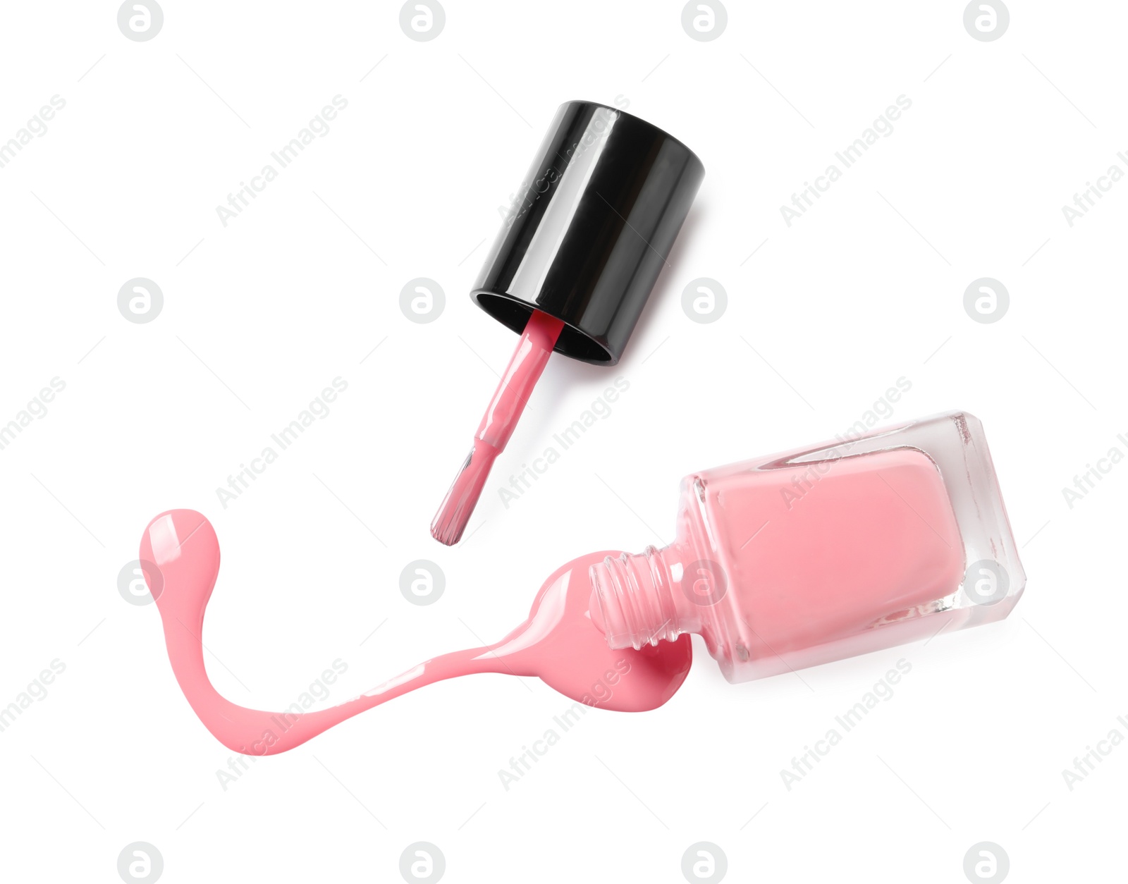 Photo of Spilled color nail polish with bottle and brush on white background, top view