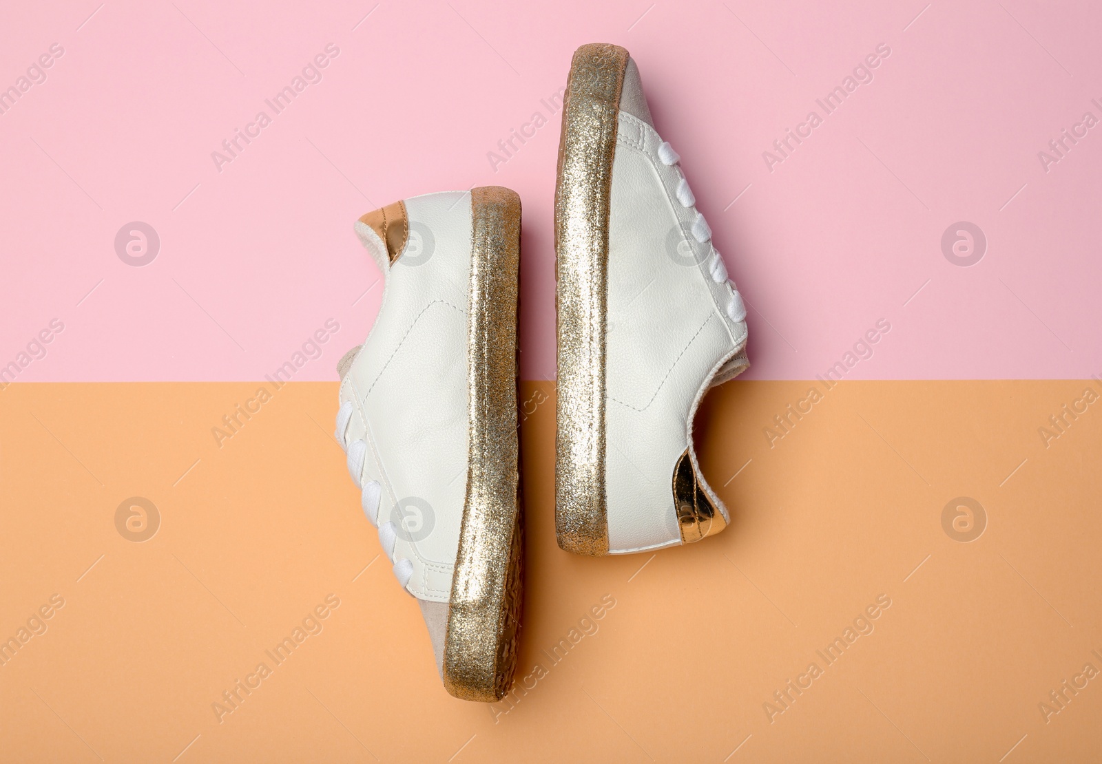 Photo of Stylish new shoes on color background, top view